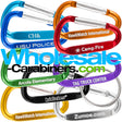Grouping of nine 2" (50mm) engraved carabiners made of anodized aluminum, in colors of light blue, dark blue, green, black, gold, orange, red,  purple and silver, customized with with logos, against a white background.
