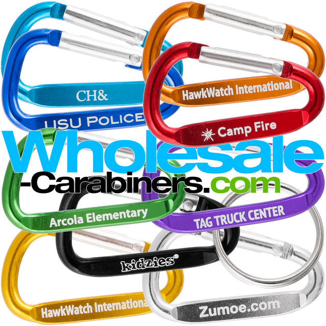 Grouping of nine 2" (50mm) engraved carabiners made of anodized aluminum, in colors of light blue, dark blue, green, black, gold, orange, red,  purple and silver, customized with with logos, against a white background.